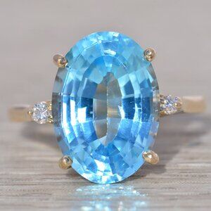Oval Blue Topaz and Natural Diamond Ring in Yellow Gold